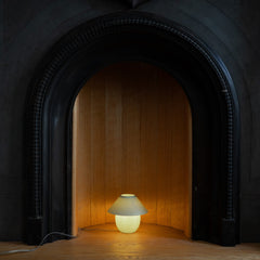 Small lamp inside a dark fireplace