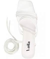 White sandal with 'Vaila' branding on a white background