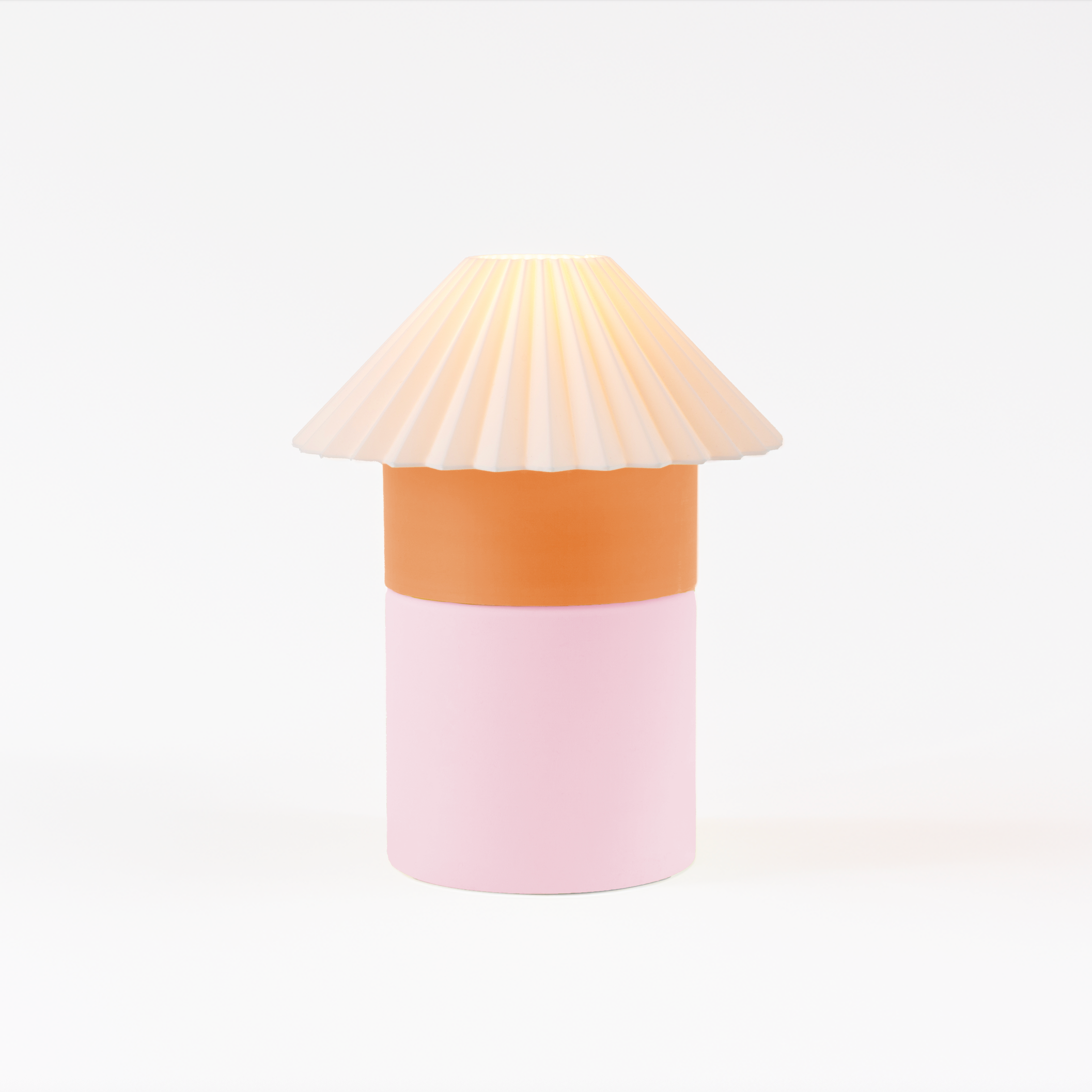 Decorative lamp with a pleated shade on a white background