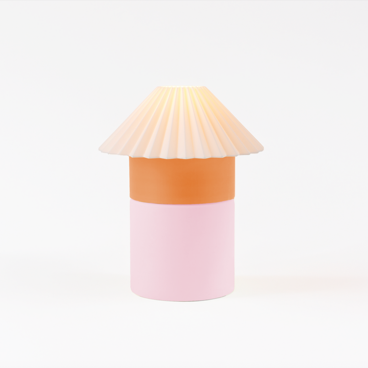 Decorative lamp with a pleated shade on a white background