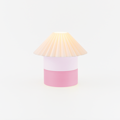 Lamp with a pink base and beige shade on a white background