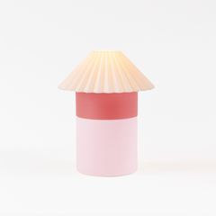 Cylindrical lamp with a pleated shade on a white background