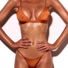 Person wearing a brown bikini against a white background