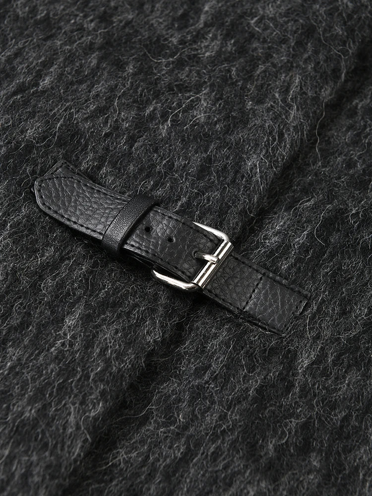 Close-up of a dark gray textured fabric with a black leather belt and silver buckle.
