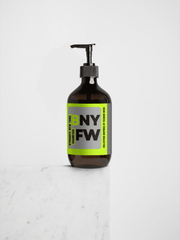 Bottle with a pump and a visible label on a light gray background