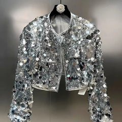 Silver sequin jacket on a hanger against a neutral background