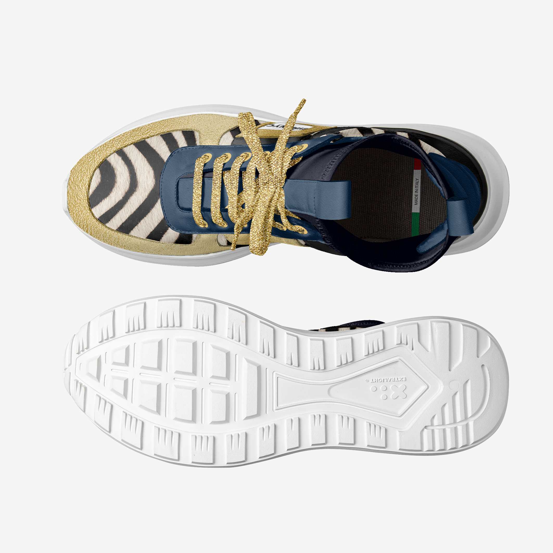 Top view of a sneaker with zebra pattern, gold laces, and white sole on a light gray background