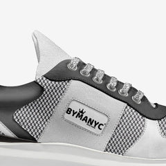 Gray and black sneaker with 'BY MANYC' branding on a white background
