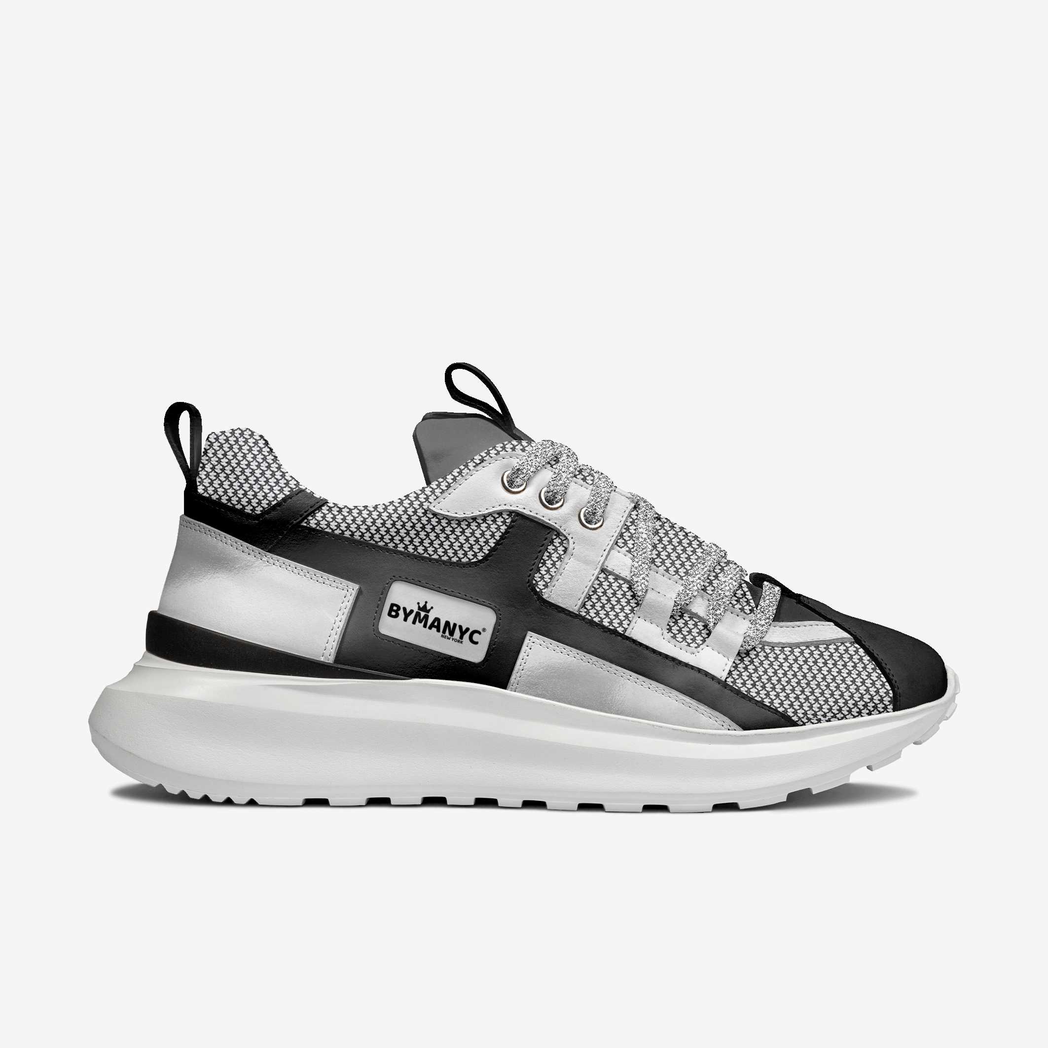 Black and gray sneaker with 'BYMANYC' branding on a white background