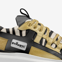 Sneaker with zebra print and gold accents on a white background