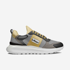 Gray and gold sneaker with 'BYMANYC' branding on a white background
