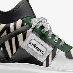Close-up of a zebra-striped sneaker with green accents and BYMANYC branding.