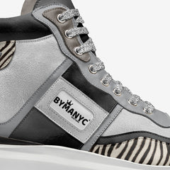 Gray and black sneaker with zebra pattern and rhinestone details, featuring the BYMANYC brand.