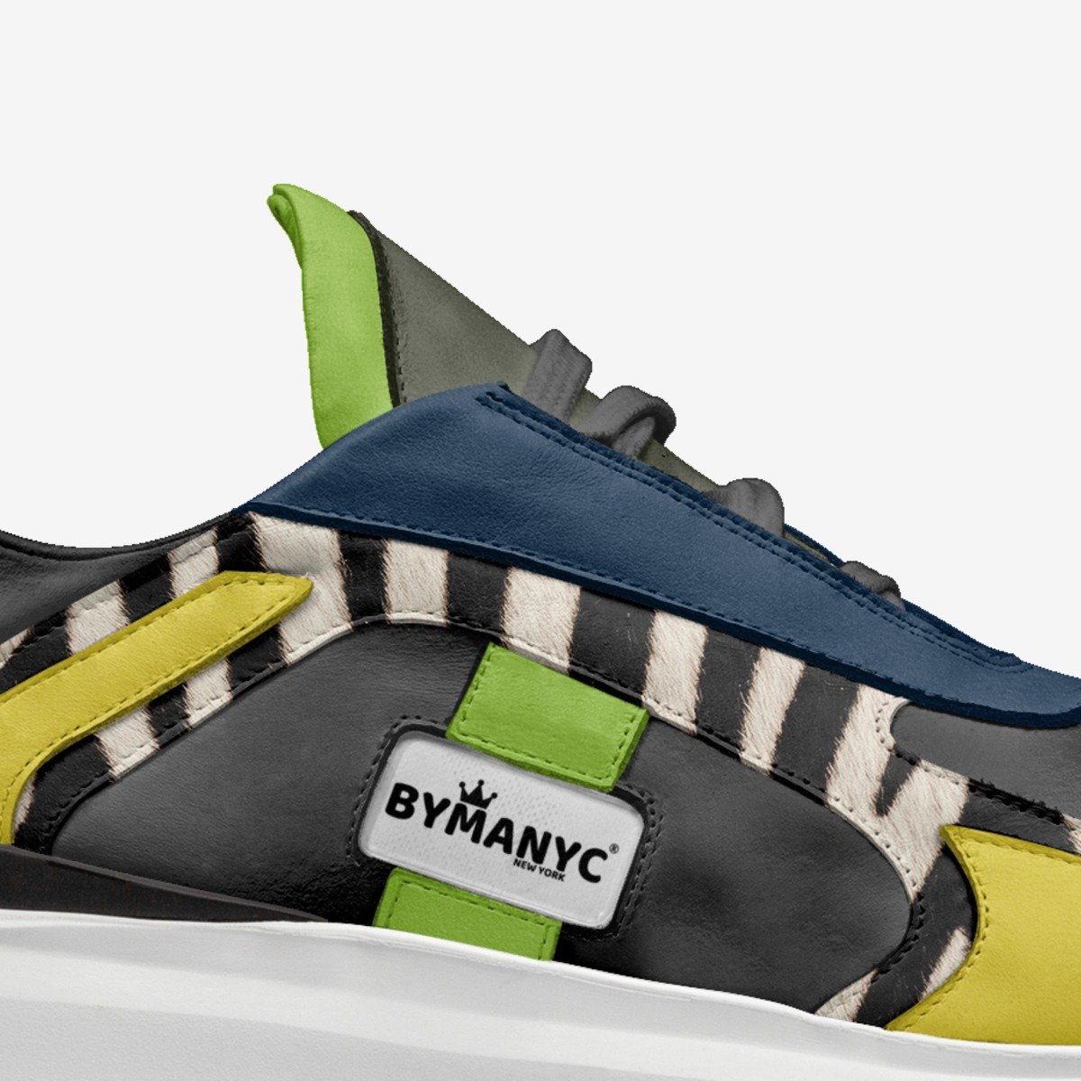 Colorful sneaker with 'BYMANYC' logo on a white background