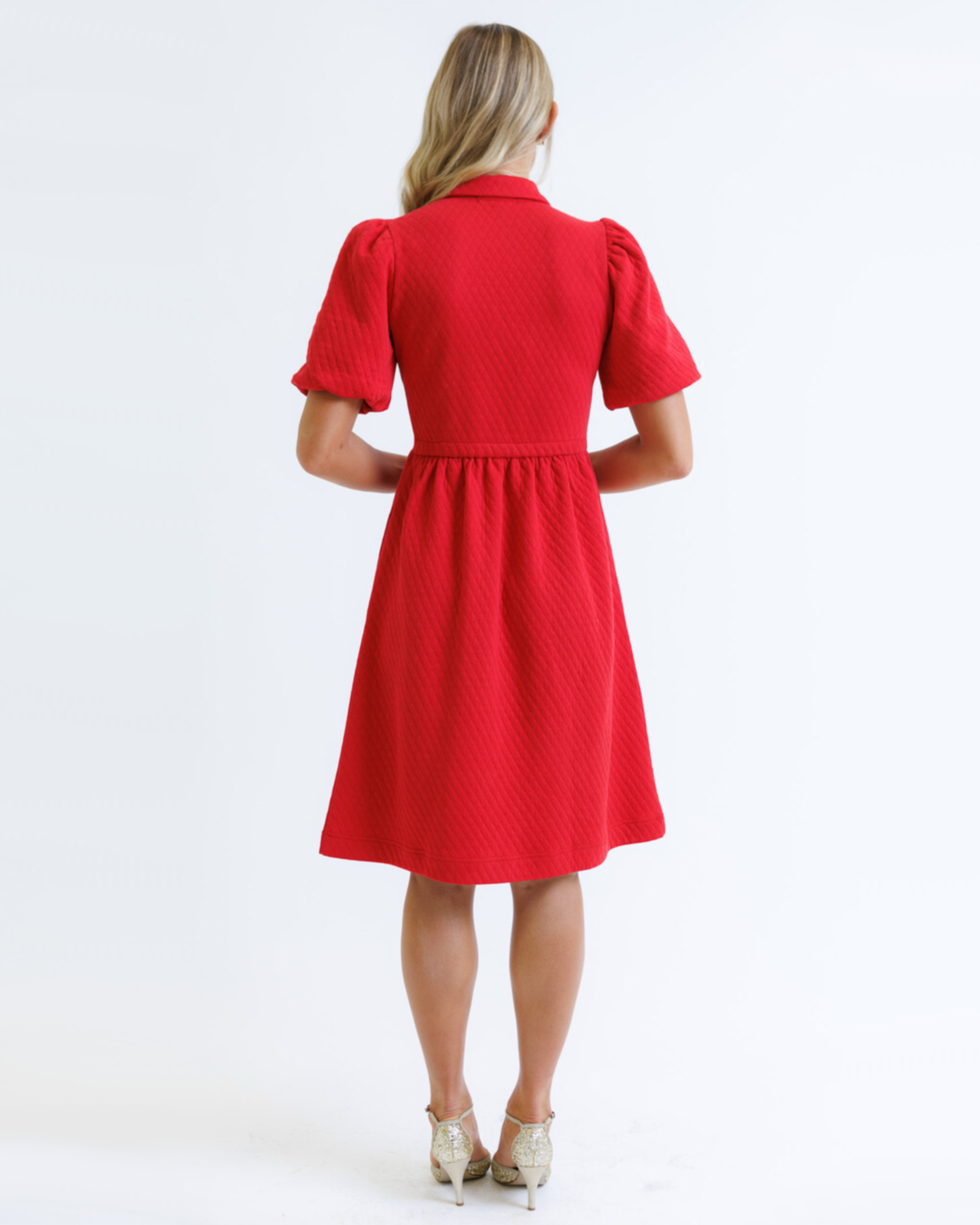 Red dress worn by a person on a white background