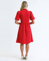 Red dress worn by a person on a white background