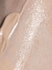 Close-up of a beige makeup product on a textured surface