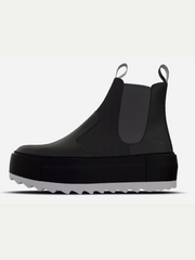 Black rain boot on a light gray background