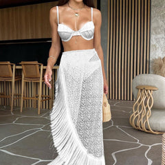 Woman wearing a white fringe skirt and top in an indoor setting.