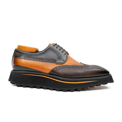 Oxford shoe with brown, orange, and gray color scheme on a white background