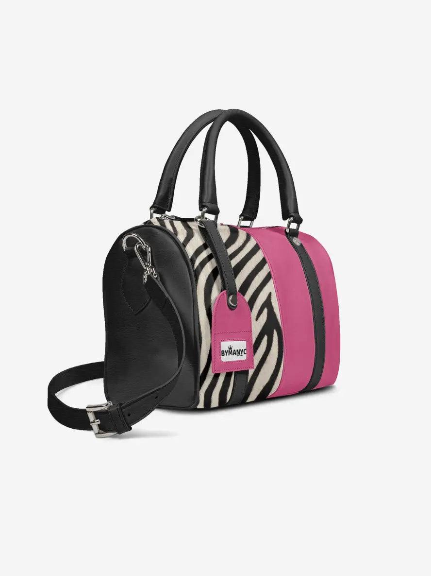 Handbag with zebra print and pink accents on a white background