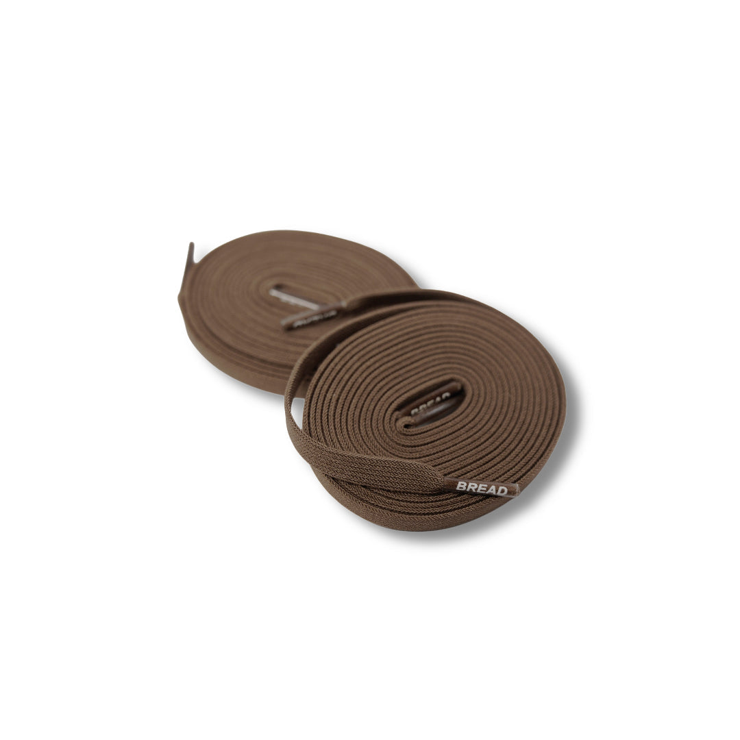 Two brown loops of webbing on a white background