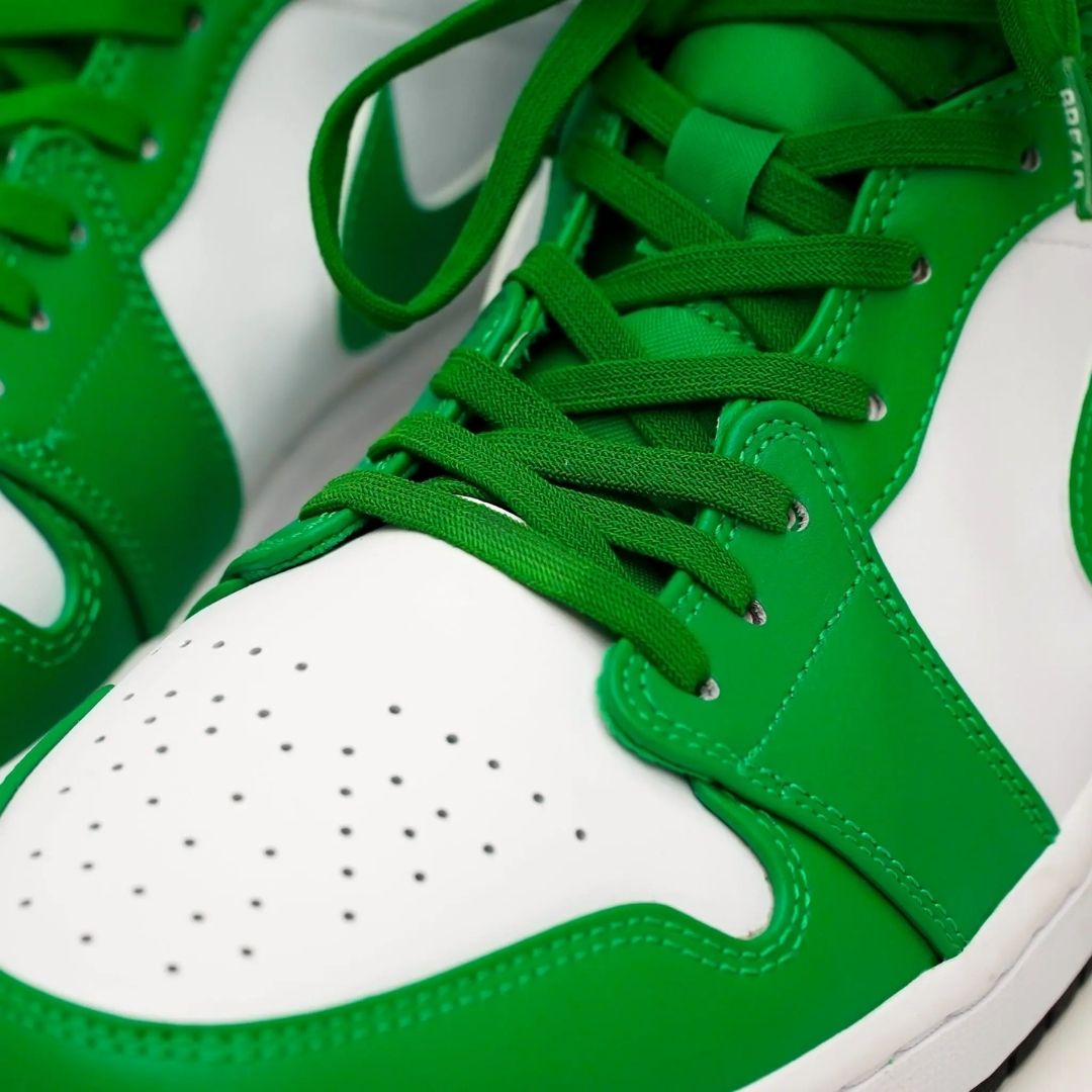 Green high-top sneakers with white soles on a light gray background