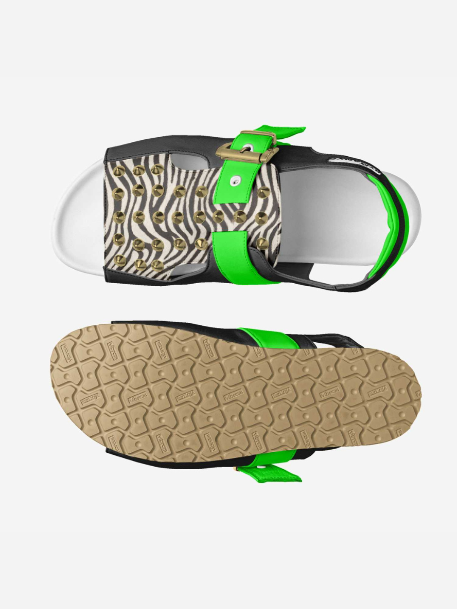 Sandal with zebra print strap and green accents on a white background