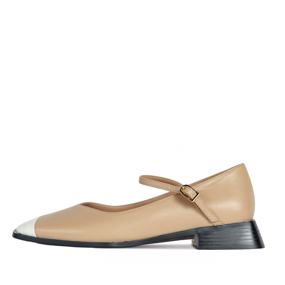 Beige shoe with a black sole on a white background