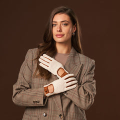 Woman wearing a plaid coat and white gloves with brown accents on a brown background