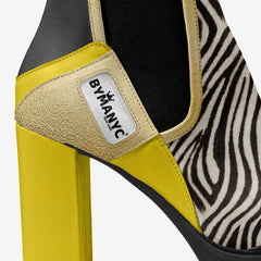 Yellow sandal with zebra pattern heel and ByManyc logo on a white background