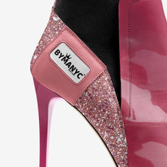 Pink high-heeled shoe with glittery detail and 'B by MAN' label on a white background