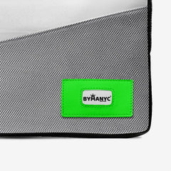 Gray bag with a green patch featuring 'BYMANYC' logo on a white background