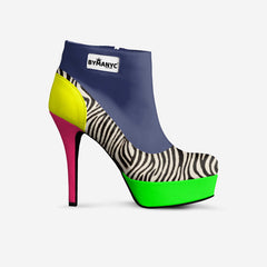 Colorful high-heeled shoe with zebra pattern and bright green sole on a white background