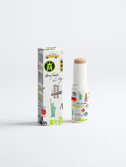 Stick of makeup with packaging featuring New York City-themed graphics on a white background