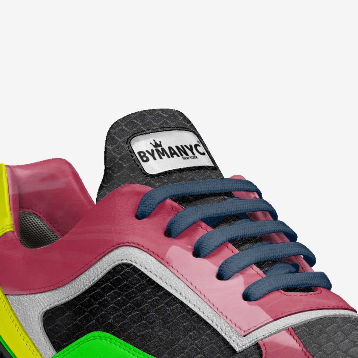 Colorful sneaker with 'BY MANYC' branding on a white background