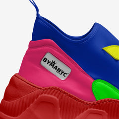 Colorful children's shoes with a visible 'BYMANYC' logo on a white background