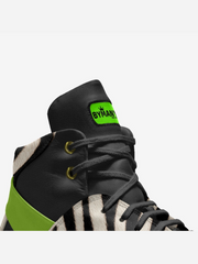 Black and green sneaker with a visible brand logo on a white background