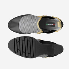 Black slip-on shoe with textured sole on a white background