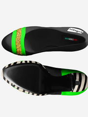 Black shoe with green and gold accents on a white background