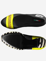 Black shoe with yellow and white accents on a white background