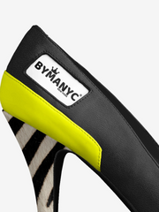 Close-up of a shoe with a Bymany brand label on a white background