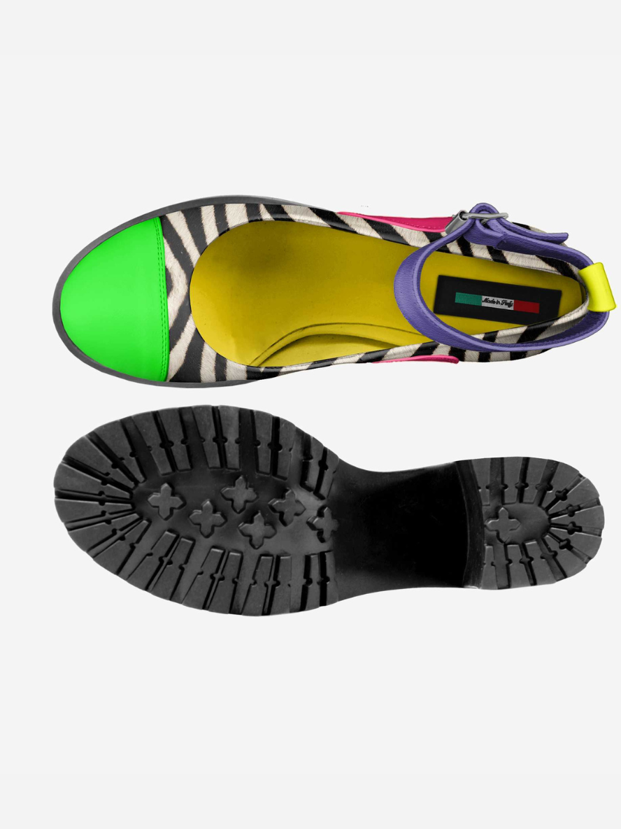 Colorful sandal with zebra pattern strap and green sole on a white background