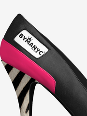 Black and pink shoe with zebra pattern sole on a white background