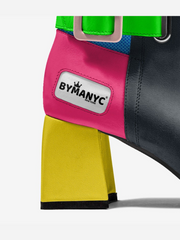 Colorful dog harness with 'BYMANYC' logo on a white background