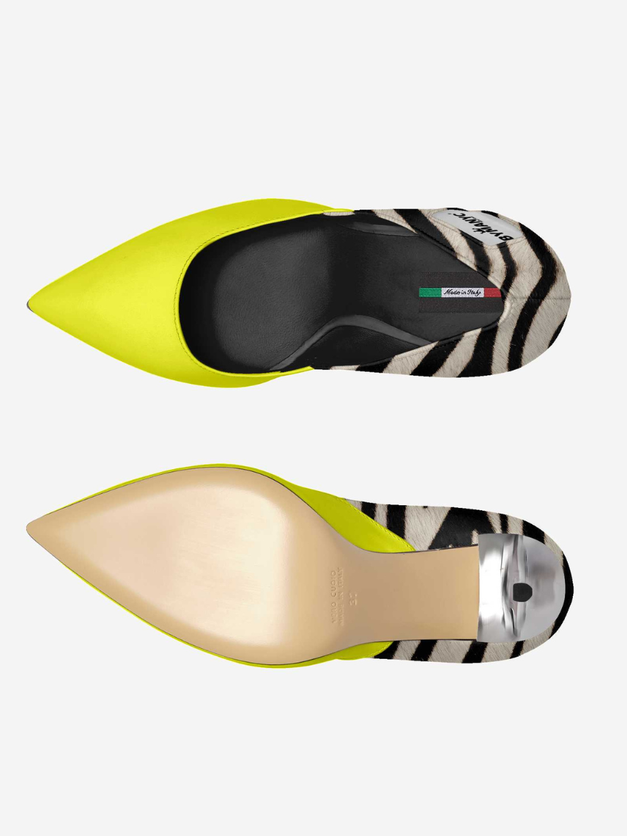 Two pointed-toe shoes with zebra pattern soles on a white background