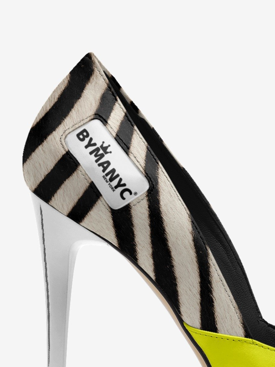 Zebra-striped high-heeled shoe with 'BYMANYC' label on a white background