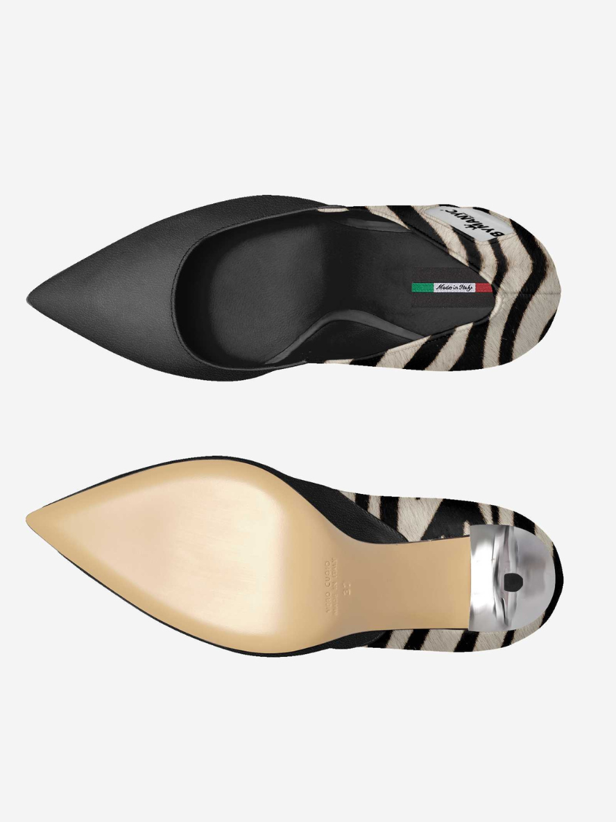 Black pointed-toe shoes with zebra pattern sole on a white background