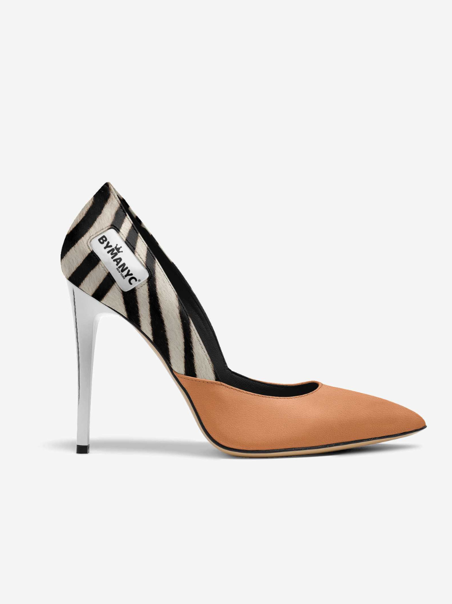 High-heeled shoe with zebra pattern and tan toe on a white background