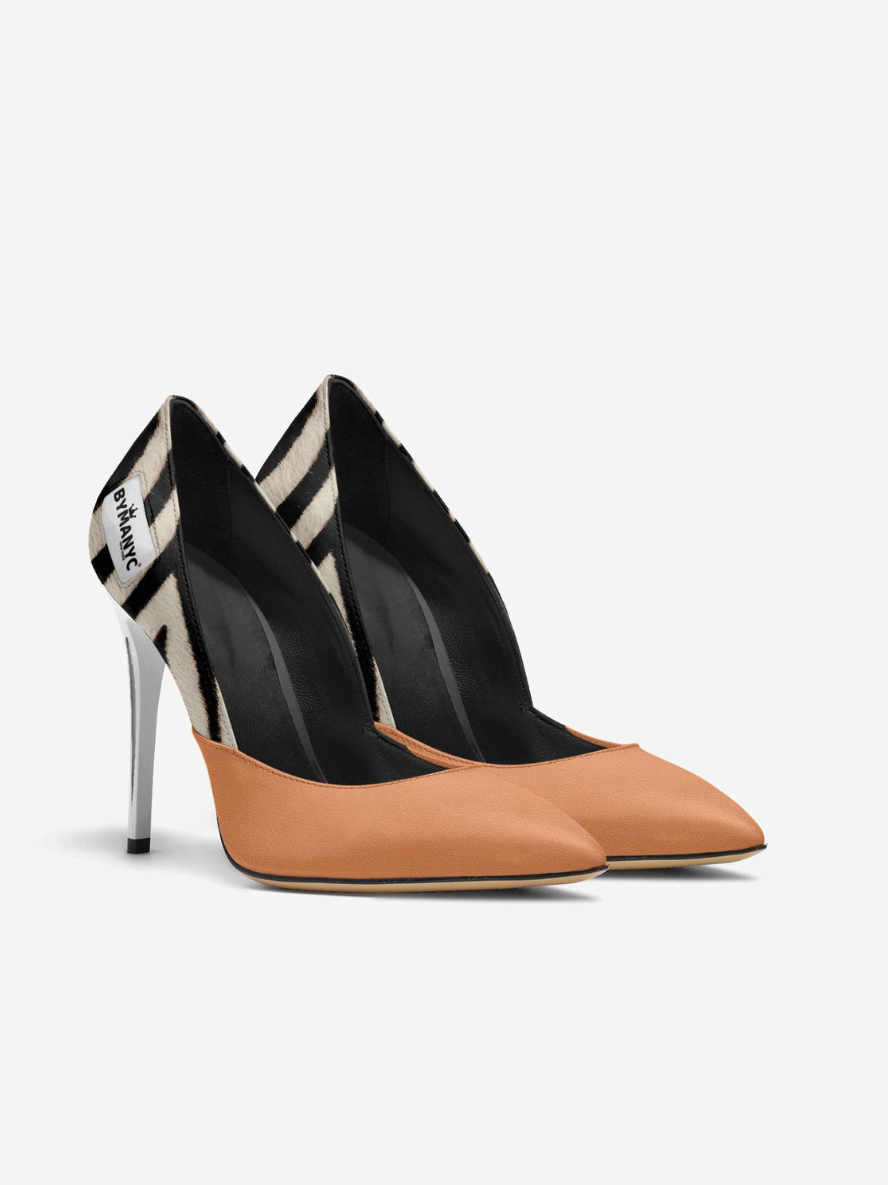Pair of high-heeled shoes with black and tan design on a white background